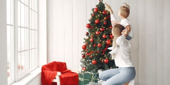 woman-has-fun-preparing-christmas-mother-white-shirt-is-playing-with-her-daughter-family-is-resting-festive-room
